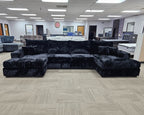 modern black velvet double chaise sectional sofa in showroom setting