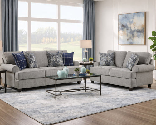 Modern gray fabric sofa and loveseat set with blue accent pillows in stylish living room