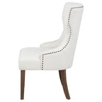 modern ivory upholstered accent chair with nailhead trim and dark wood legs for living room