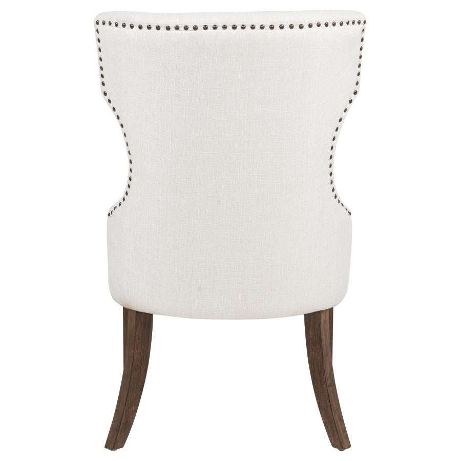 modern cream upholstered accent chair with nailhead trim and dark wood legs for living room