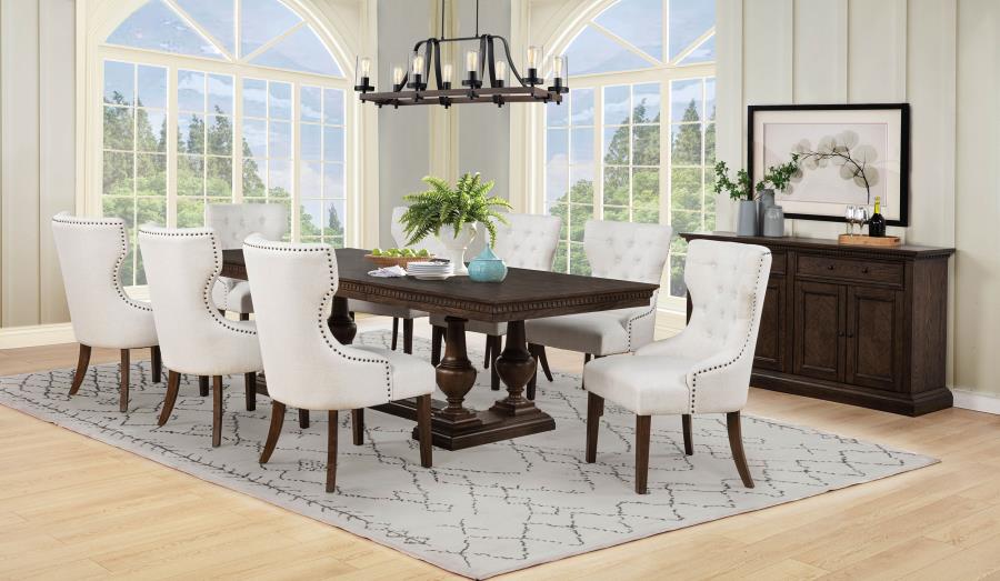 modern dark wood dining table with eight tufted white chairs in elegant dining room