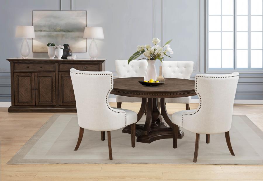 modern dark wood round dining table with cream upholstered chairs in elegant dining room
