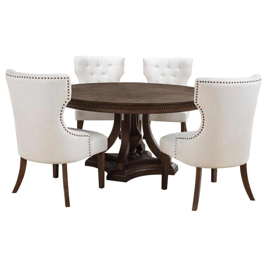 round dark wood dining table with four cream upholstered chairs, traditional style