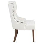 modern white upholstered dining chair with nailhead trim and dark wood legs