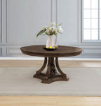Round dark wood dining table with pedestal base in elegant dining room setting