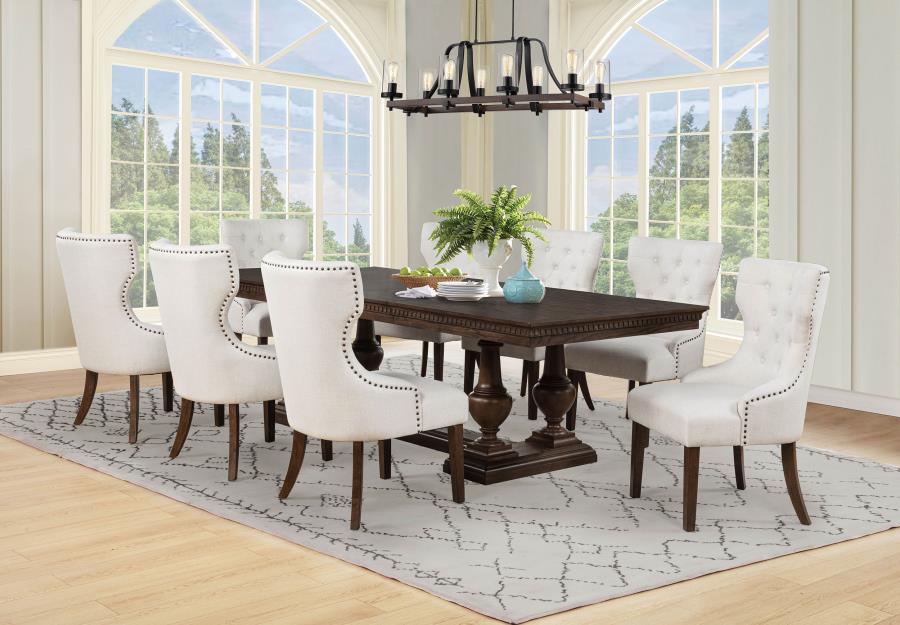 modern dark wood dining table with eight tufted cream chairs in bright dining room