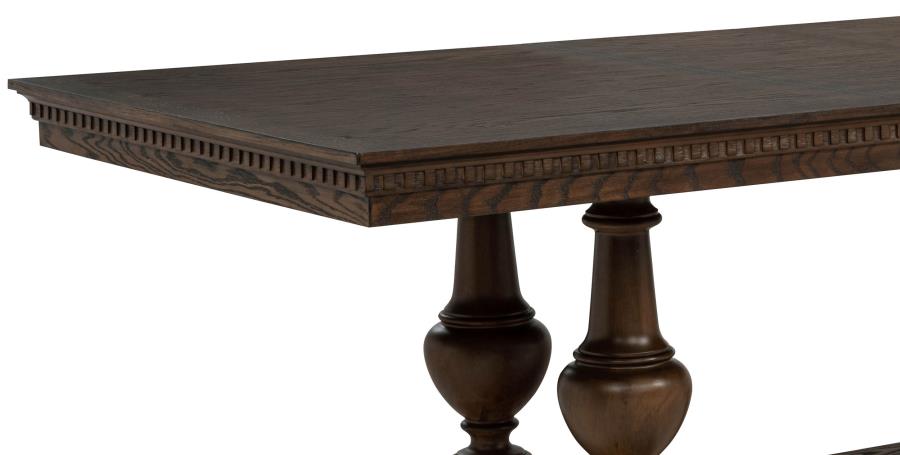 dark wood dining table with carved edges and turned pedestal legs, classic dining room style