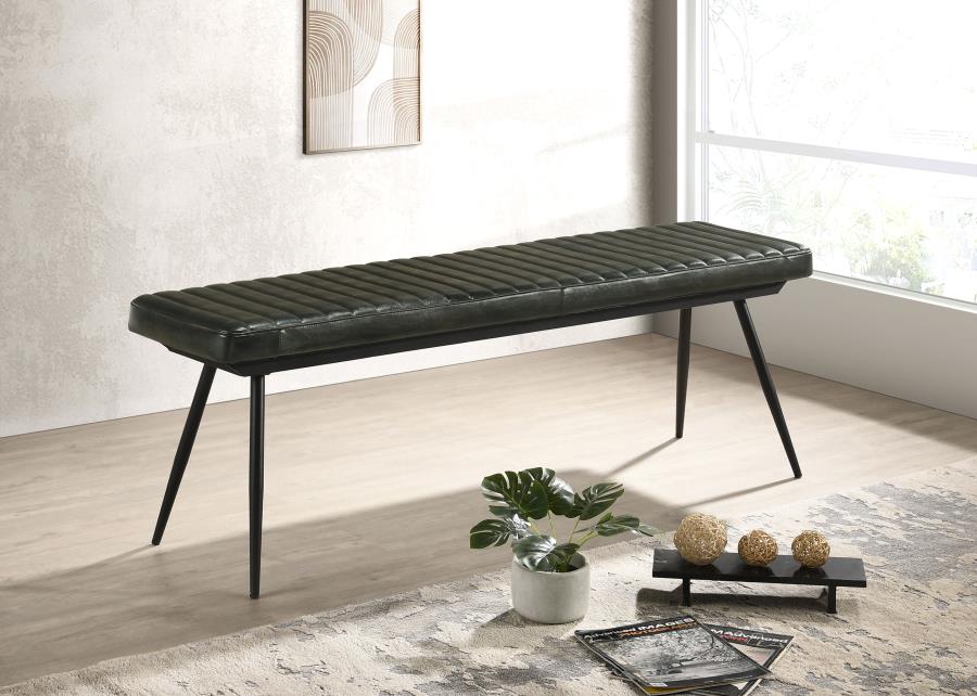 Modern black leather upholstered dining bench with tapered metal legs positioned beside a bright window.