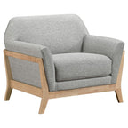 Grey upholstered accent chair with flared arms and natural wood frame on angled legs