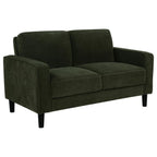 Matcha green fabric loveseat with track arms, two cushions, and black tapered legs on white background.