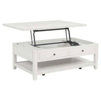 White distressed wood coffee table with lift-top mechanism open, two drawers, lower shelf, and casters.