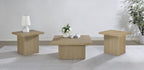 Three light wood square tables arranged in a bright, minimalist living room with white walls and natural light.