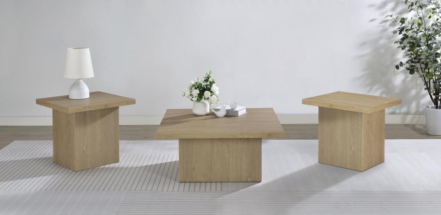 Three light wood square tables arranged in a bright, minimalist living room with white walls and natural light.