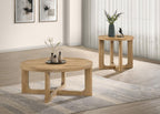 Two light oak round coffee tables with sculptural wooden bases arranged on a gray area rug in a minimalist living room.