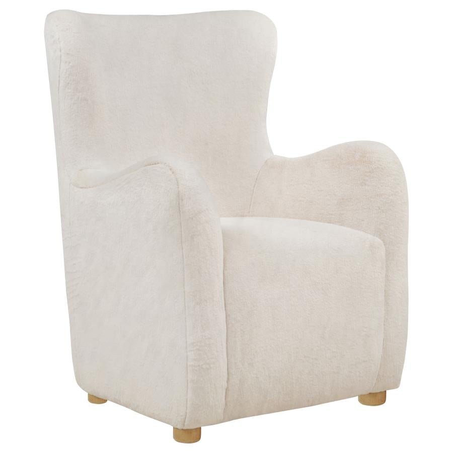 Ivory faux fur wingback lounge chair with curved arms and natural wood legs on white background.
