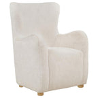 Ivory faux fur wingback lounge chair with curved arms and natural wood legs on white background.
