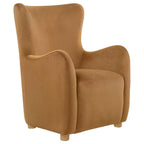 Cognac velvet wingback lounge chair with high back, curved armrests, and wooden feet.